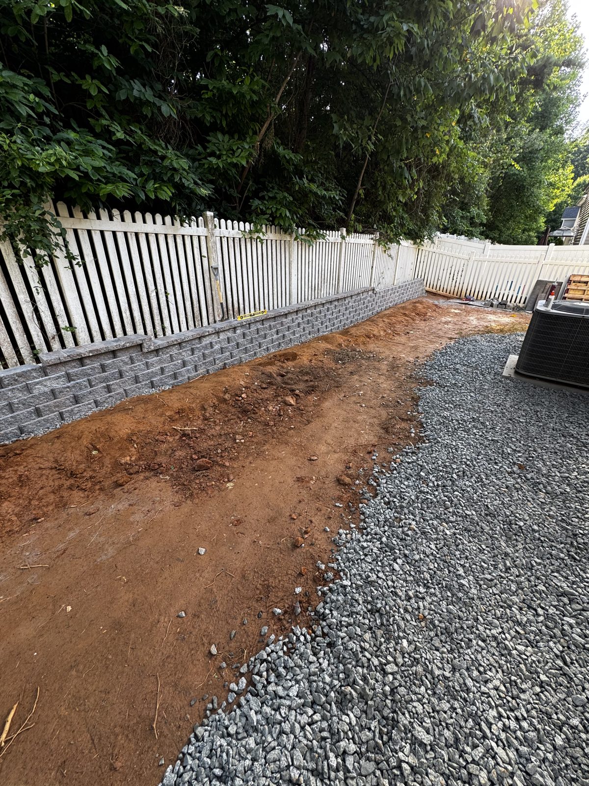 Compacted gravel base spread across the yard