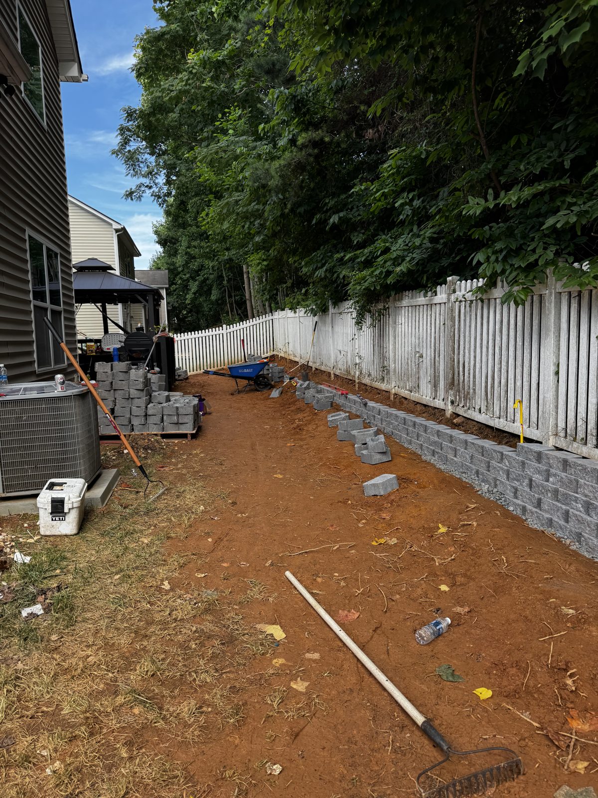 Segmental retaining wall going in course by course